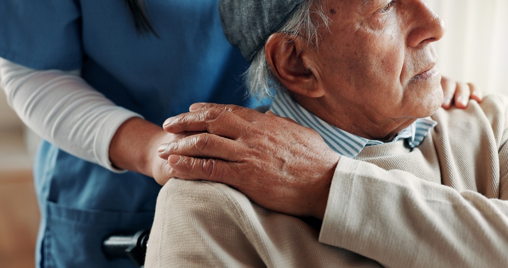 Caregiver, holding hands or old man in wheelchair at nursing home, support or trust for rehabilitation. Assisted living, nurse or senior person with disability for medical care, comfort or kindness