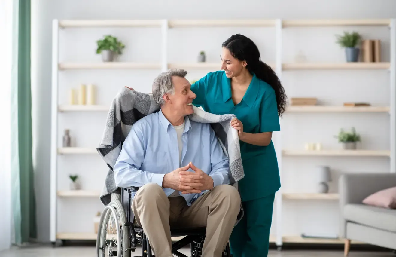 caregiver-assisting-elderly-man-in-wheelchair-outdoors-ballagh-care