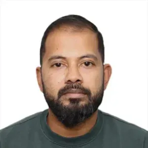 Man looking straight at the camera with facial hair and dark eys